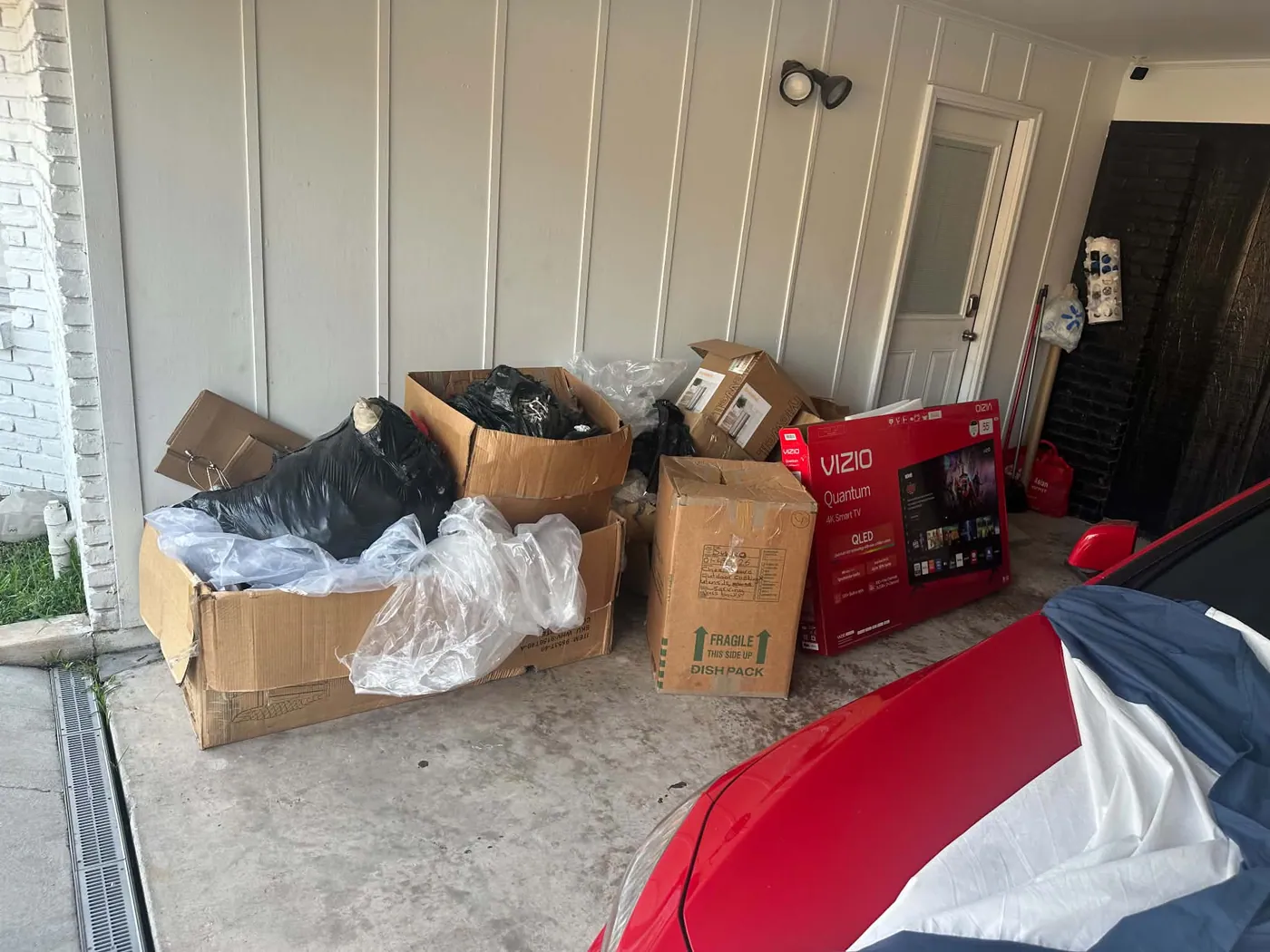 Residential garage filled with boxes, bags, and unwanted items